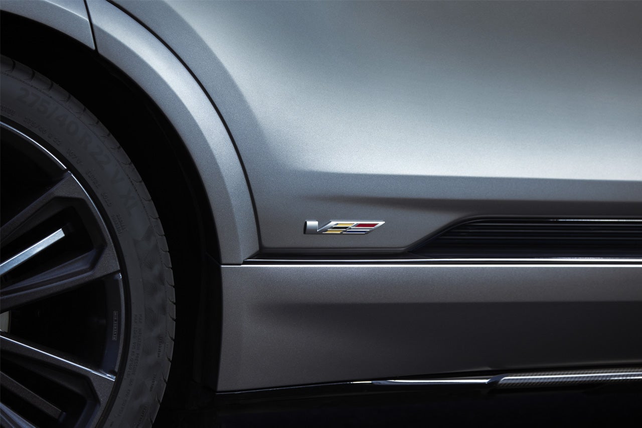 Close-up of a Woman Walking Past the 2025 Cadillac XT4 Grille